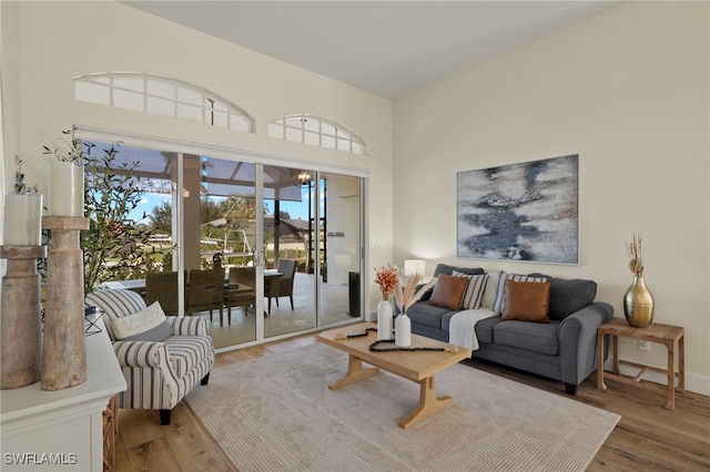 living room with a chandelier and wood finished floors