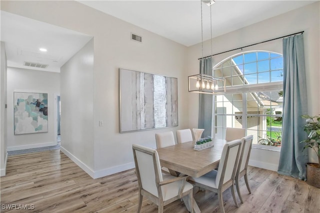 5661 Harborage Dr, Fort Myers, FL 33908 - dining room with light wood-style floors, baseboards, and a chandelier