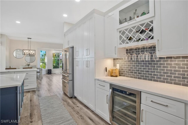 5661 Harborage Dr, Fort Myers, FL 33908 - indoor dry bar featuring wine cooler, high end refrigerator, decorative backsplash, decorative light fixtures, and light wood finished floors