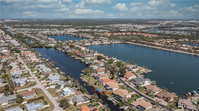 birds eye view of property with a residential view and a water view