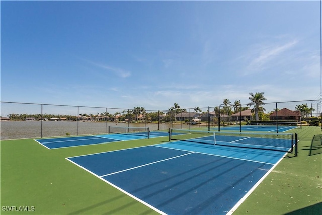 view of tennis court featuring fence