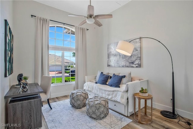 sitting room with light wood-type flooring, ceiling fan, and baseboards