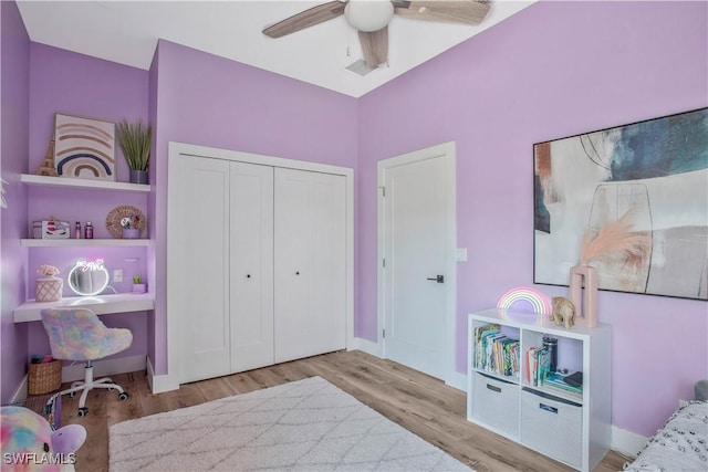 bedroom featuring baseboards, a closet, a ceiling fan, and wood finished floors