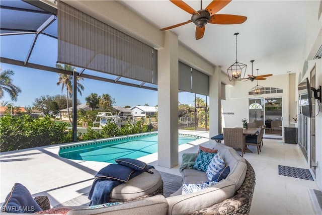 outdoor pool with a lanai, an outdoor hangout area, a ceiling fan, and a patio