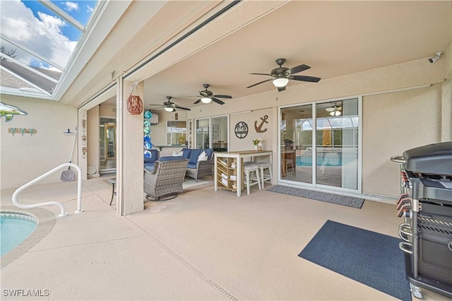 view of patio with glass enclosure, an outdoor living space, and a ceiling fan