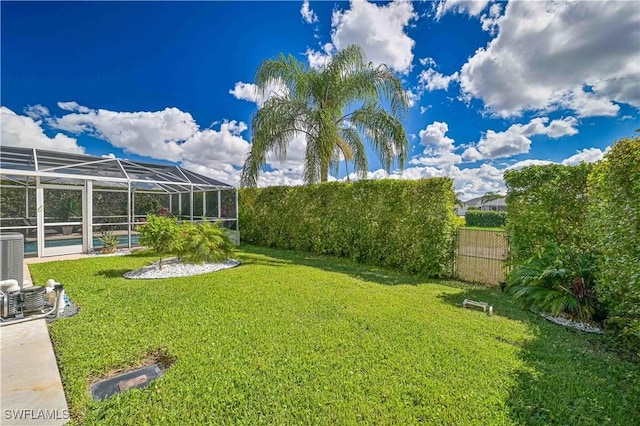 view of yard with a lanai, an outdoor pool, and fence