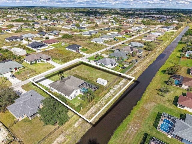 bird's eye view with a residential view and a water view