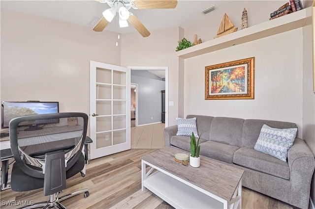 office space with a ceiling fan, french doors, visible vents, and light wood-style flooring