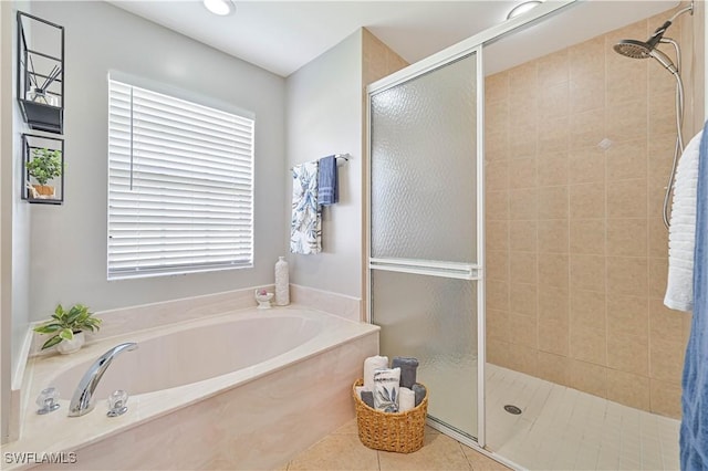 full bath with tile patterned flooring, a garden tub, and a shower stall