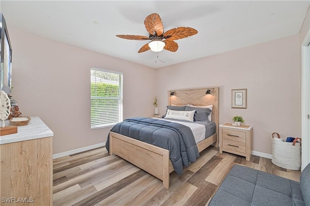 bedroom featuring light wood-style floors, ceiling fan, and baseboards