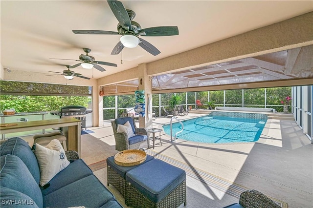 pool with a patio, glass enclosure, an outdoor hangout area, a ceiling fan, and grilling area