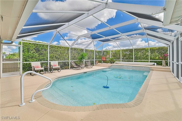 outdoor pool with a lanai and a patio