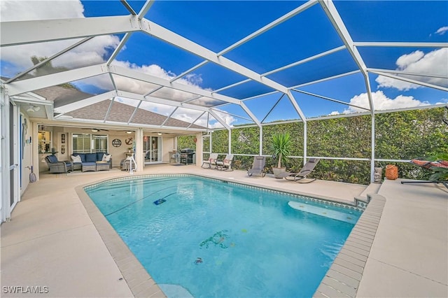 outdoor pool featuring a lanai, a patio area, and an outdoor living space