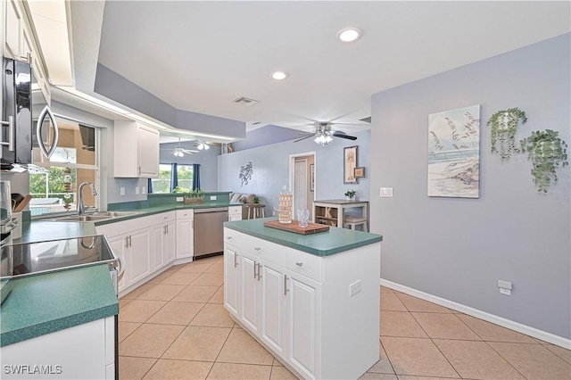 kitchen with a center island, white cabinetry, light tile patterned flooring, ceiling fan, and dishwasher