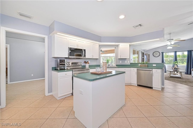 kitchen with appliances with stainless steel finishes, a wealth of natural light, visible vents, and light tile patterned floors