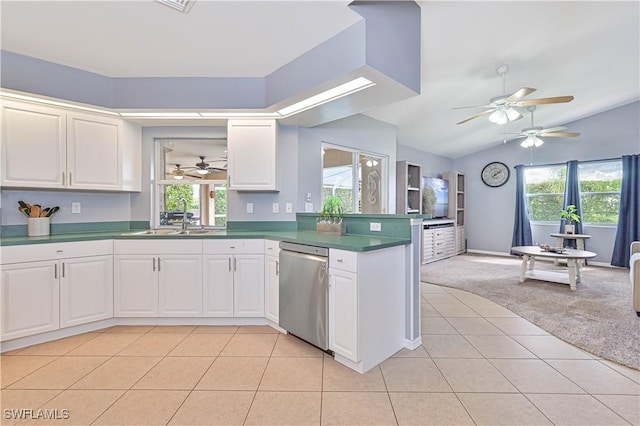 kitchen with light carpet, dishwasher, a peninsula, and light tile patterned floors