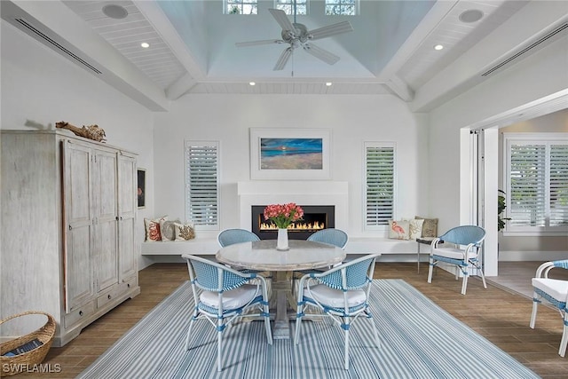 dining area with recessed lighting, visible vents, wood finished floors, a lit fireplace, and baseboards