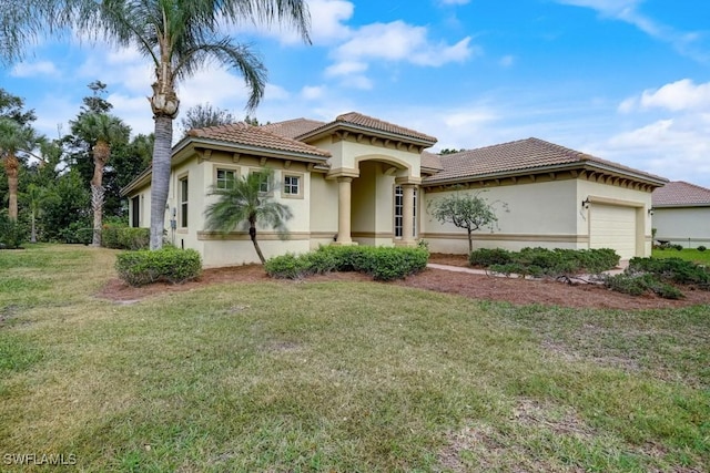 mediterranean / spanish-style home with a garage and a front yard