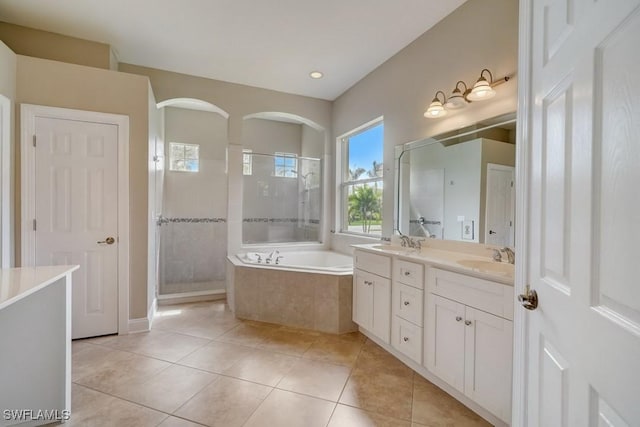 bathroom featuring shower with separate bathtub, tile patterned flooring, and vanity