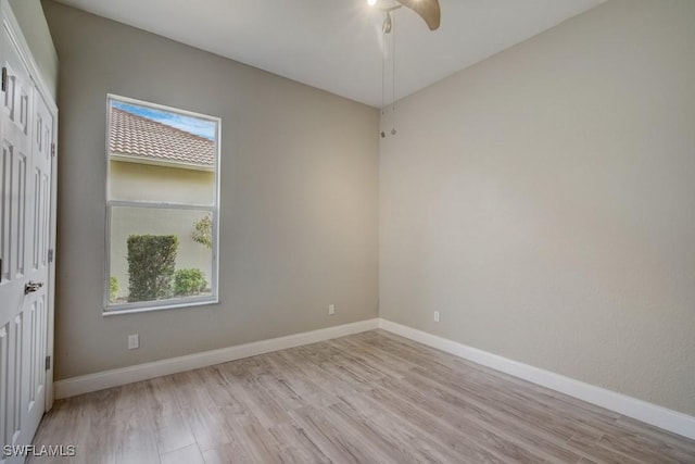 unfurnished room with light wood-type flooring, ceiling fan, and a wealth of natural light