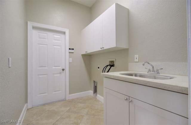 laundry area featuring cabinets, hookup for an electric dryer, hookup for a washing machine, sink, and light tile patterned floors