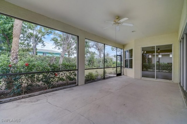 unfurnished sunroom featuring ceiling fan