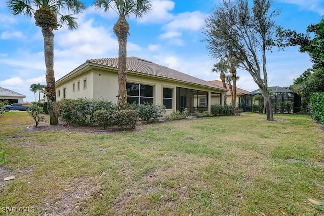 rear view of property with a yard