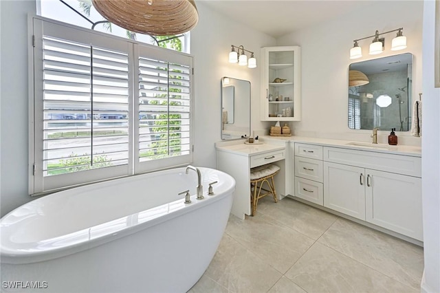 full bathroom featuring a soaking tub, plenty of natural light, vanity, and tile patterned floors