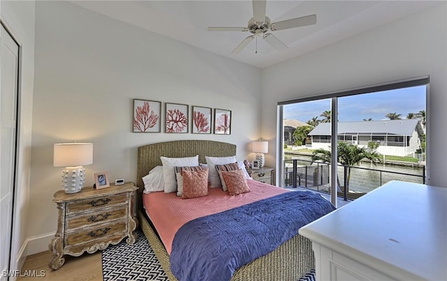 bedroom featuring baseboards, wood finished floors, a ceiling fan, and access to exterior