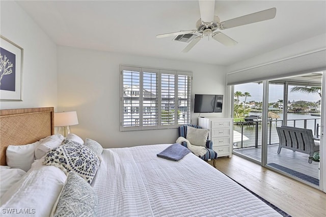 bedroom featuring access to exterior, dark wood-type flooring, visible vents, and a ceiling fan