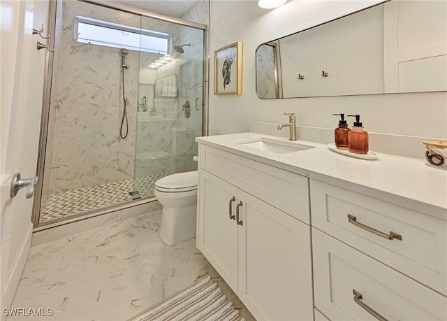 bathroom with toilet, marble finish floor, a shower stall, and vanity