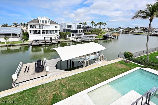 view of dock with a yard, boat lift, a water view, fence, and an outdoor pool