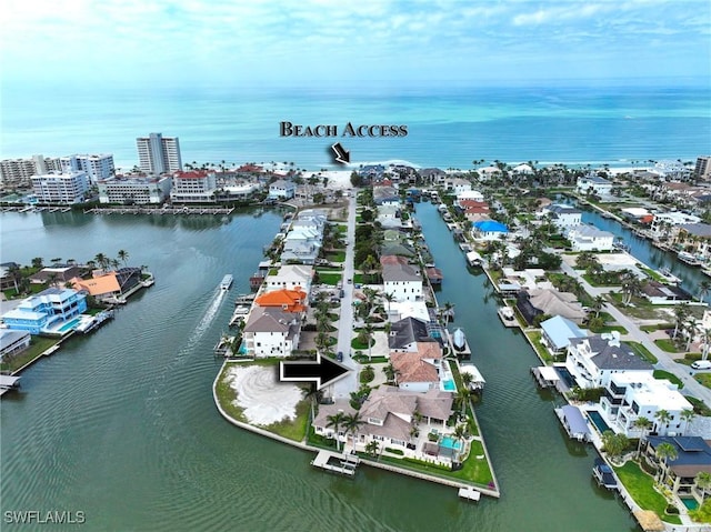 birds eye view of property with a water view and a city view