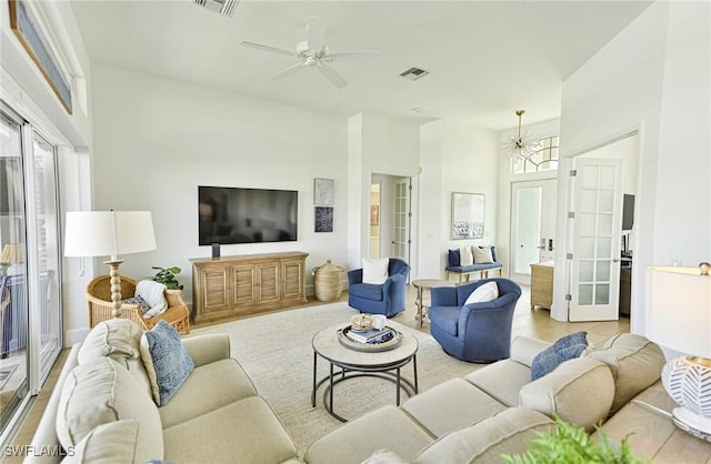 living room featuring visible vents, french doors, and a ceiling fan