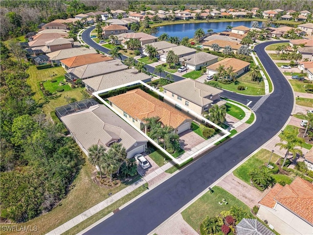 birds eye view of property with a water view and a residential view