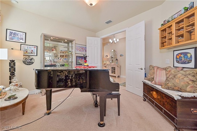 sitting room featuring baseboards, visible vents, a notable chandelier, and light colored carpet