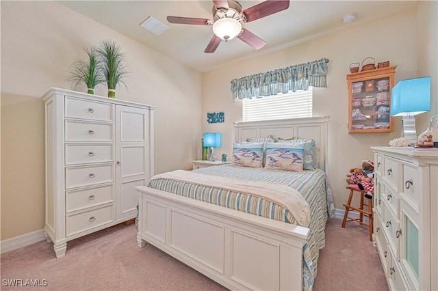 bedroom featuring light carpet, baseboards, visible vents, and a ceiling fan