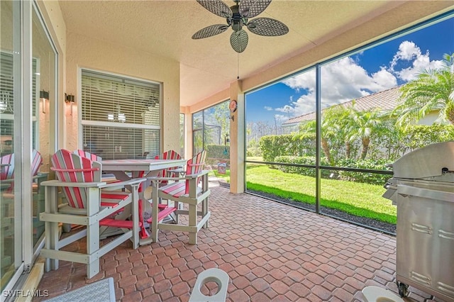 sunroom with a ceiling fan