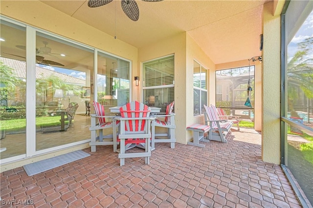 sunroom featuring a ceiling fan