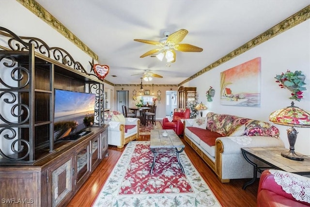 living area with ceiling fan and dark wood-style flooring