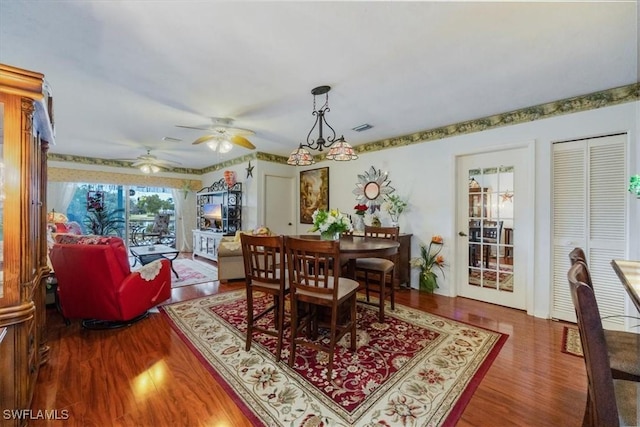 dining area featuring ceiling fan, visible vents, and wood finished floors