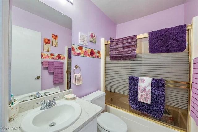 full bathroom with enclosed tub / shower combo, toilet, and vanity