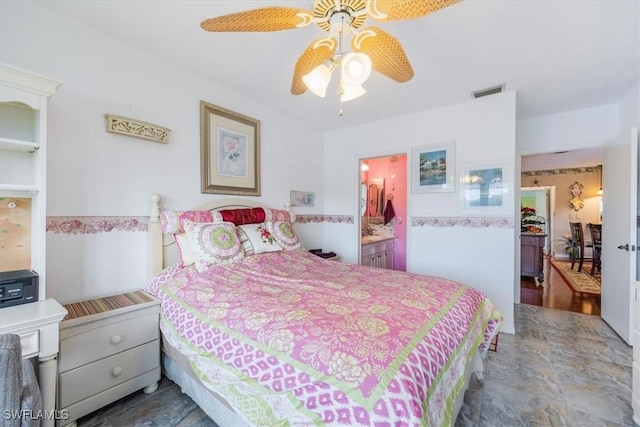 bedroom with connected bathroom, visible vents, and a ceiling fan