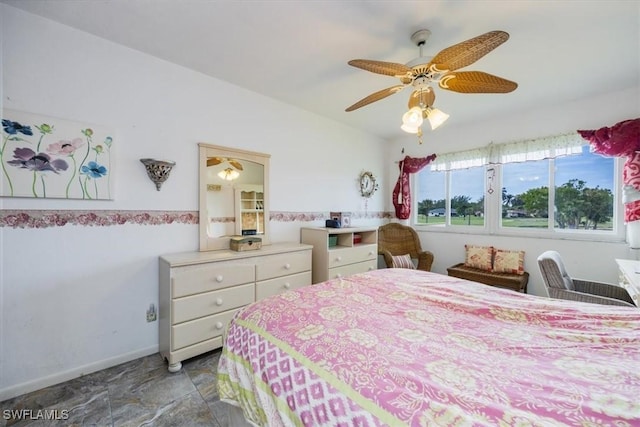 bedroom featuring a ceiling fan and baseboards