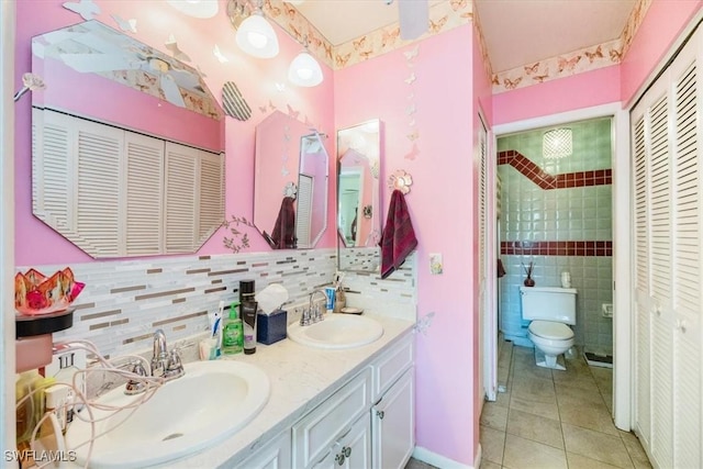 full bathroom featuring a closet, a sink, toilet, and tile patterned floors