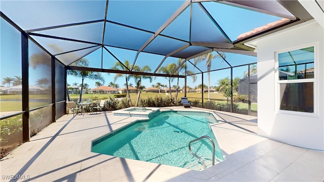 view of pool featuring a pool with connected hot tub, a lanai, and a patio