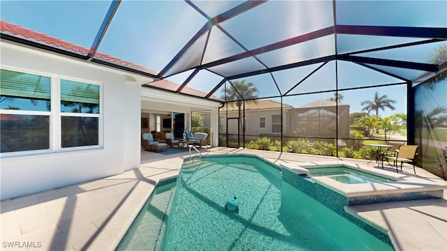 view of pool featuring a patio area, a pool with connected hot tub, and glass enclosure