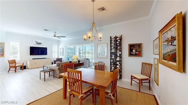 dining space featuring ornamental molding, baseboards, visible vents, and light wood finished floors