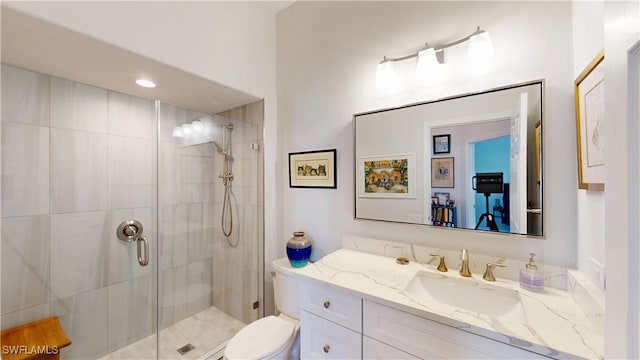 full bathroom with toilet, a shower stall, and vanity