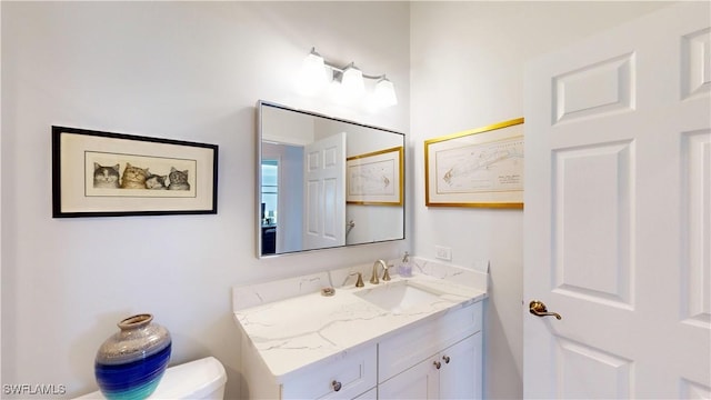 bathroom with toilet and vanity